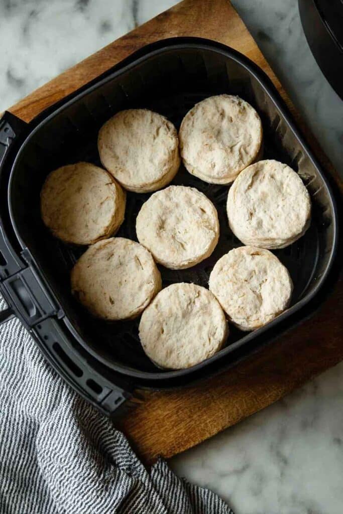 Air fryer canned biscuits cooking at 350°F showing golden browning process